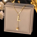 Detail of gold titanium steel necklace with letter L pendant on jewelry box - Letter L-Gold