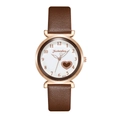 Detail of rose gold watch case with brown leather strap and heart-shaped dial cutout - Brown
