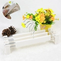 Close-up of white plastic pants hanger with adjustable clips and non-slip inner texture - Nordic White