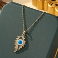 Macro shot of evil eye pendant with blue enamel and pavé crystals on gold necklace - A3-Gold