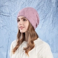 Pink slouchy beanie with wave texture and pearl accents worn by a model in snow - Leather Purple