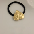 Gold heart-shaped elastic hair tie with textured metallic finish and black cord - Pattern Heart Gold