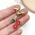 Handheld gold cherry pendant with vibrant red and green rhinestones for DIY jewelry - KC Gold Red Rhinestone Cherry (23425)