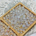 Macro shot of transparent iridescent round beads for DIY jewelry making on a tray - 10mm / Aurora AB Transparent White
