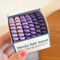 Set of 6 spiral hair ties in purple gradient colors in a blue and white paper box - Purple Series