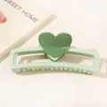 Detail of green heart hair claw clip with rectangular cutout and dual-tone acrylic design - Heart Hollow Rectangle / Light Green