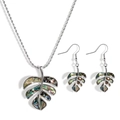 Macro view of monstera leaf jewelry set with colorful abalone shell inlay details - Silver