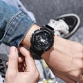 Close-up of black digital sports watch with rubber strap worn in a casual lifestyle setting - Black