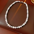 Detailed shot of tricolor pearls on a dark leather base with a silver metal clasp - Choker Necklace (WN1234) / Three-color Pearls (White/Grey/Pink Purple)