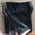 Bulk pack of disposable black plastic forks in transparent packaging for neon parties - Black Forks