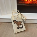 Close-up of beige knitted mini bag featuring a brown horse pattern with visible textures - Horse Pattern Beige