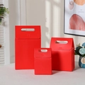 Set of three red kraft paper gift bags with handles in different sizes for packaging - Red