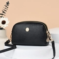 Crossbody bag in black lychee texture leather with gold dual zipper and shell silhouette - Black