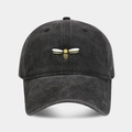 Close-up of vintage washed grey baseball cap with detailed bee embroidery and denim texture - Black