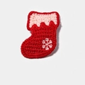 Detailed close-up of handmade red knit Christmas sock hair clip with snowflake embroidery - Knitted Christmas Stocking