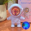 Blue astronaut sunset projector lamp with warm purple and orange atmospheric glow - Astronaut Sunset Lamp Ornament / Purple