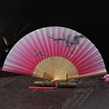 Close-up of pink gradient silk fan with bamboo carvings and decorative tassel - Pink Double Plum Blossom