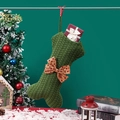 Green knit bone-shaped pet Christmas stocking with red bow and gold dots for decor - Knitted Bone Stocking / Green
