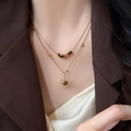 Double-layer gold necklace with tiger eye beads and sun pendant on female model - Double Layer Sun Shape Pendant Necklace (4#) / Gold Brown