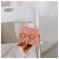 Pink mini jelly bag with golden chain and top handle shown in a high-quality lifestyle shot - Pink