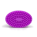 Purple oval silicone cleansing brush with soft textured bristles on white background - Flat Head Handheld Style / Fuschia