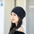 Dettaglio di un elegante berretto in pizzo nero da donna con perle bianche e strass scintillanti - Adulto (55-60cm) / Nero