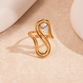 Close-up of golden wavy open ring featuring a teardrop-shaped zircon stone detail - Gold Twisted