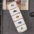 Five pairs of white cotton mid-calf socks with colorful embroidery in a beige organizer - 5 Pairs / White Combo 1