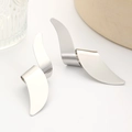 Macro detail of glossy silver twisted geometric earrings with abstract curved metal lines - White Gold Color (N-054)