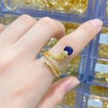 Macro detail of snake ring with blue gemstone head and white zircons on finger - Dark Blue Round Stone Gold Snake Open Ring