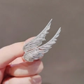 Elegant silver wing brooch featuring shimmering inlaid crystals in a handheld view - 443# Silver Feather