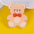 Cute brown acrylic bear pin with red bow detail on a bright yellow background - Bear with Bow