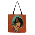 Detailed view of reusable tote bag with artistic African woman print and King graphic - Warm Orange-Afro Lady Portrait-KING Hoodie