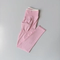 Flat lay of pink seamless yoga pants featuring high waist design and peach butt lifting texture - Bubble Pink