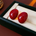 Macro shot of glossy red oval earrings set in a premium green leather jewelry box - Oval Style (1#)