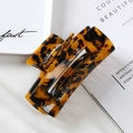 Detailed close-up of a 10cm acetate tortoiseshell hair claw clip with hollow design - 4# Tortoiseshell 10cm Acetate Claw Clip