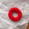 Detail of red plush faux rabbit fur hair tie with soft texture and elastic core - Red