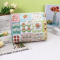 Quilted cotton makeup bag featuring mixed cartoon prints and a functional zipper closure - Patchwork Flower Girl