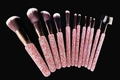 Detail view of 12 luxury rhinestone makeup brushes with pink handles on black background - Mixed Pink