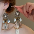 Detailed view of Bohemian tassel earrings with beads, wood, and shells on model - Round Drip Oil Wood Bead Flower Conch Chain Style
