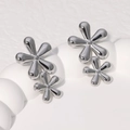 Elegant silver stainless steel double flower stud earrings with a polished metallic finish - Steel