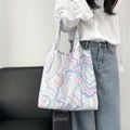 Detail of floral canvas tote bag with blue and red marble pattern on a shoulder - Blue and White Waves