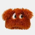 Detail of orange faux fur plush hat featuring large cartoon eyes and fluffy texture - Caramel color