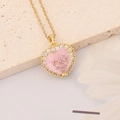 Macro detail of gold necklace with pink heart pendant surrounded by clear crystals - Crackle Hearts