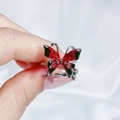Detail of red and black enamel butterfly ring with silver open band held by hand - Vintage Red Black Butterfly Ring (JZ3749)