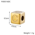 Macro shot of gold square bead with letter C, 0.5cm cube pendant in stainless steel - Letter C / Gold