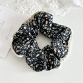 Close-up of black floral fabric scrunchie with beige lace trim on aesthetic background - Black Floral With Lace Edge
