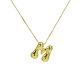 Macro shot of 18k gold plated brass puffy balloon letter M pendant on a fine box chain - Letter M