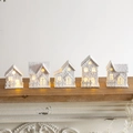 Set of five white LED wooden cottages with snow texture and warm yellow light - 5 Flocked White Wooden Houses Set