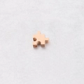 Macro detail of rose gold puzzle piece charm with visible 1.8mm hole for jewelry making - 10*10mm / 18K Rose Gold Plated